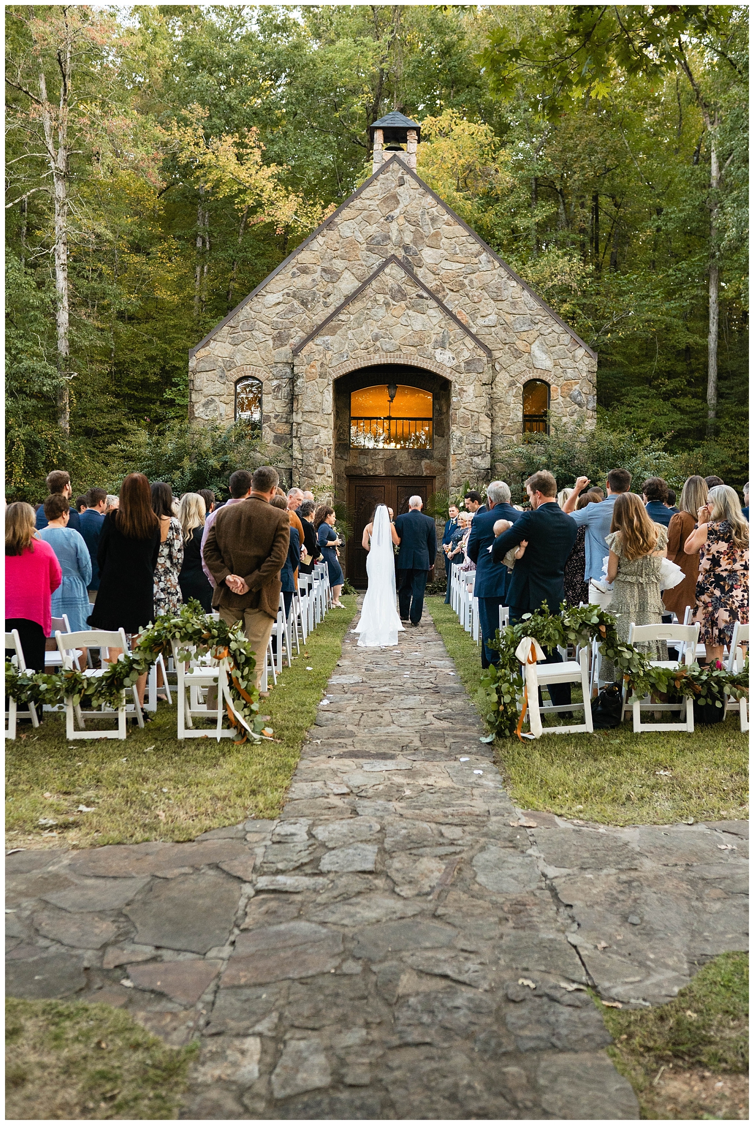 wedding ceremony space rock chapel by creek dad walking bride down aisle 